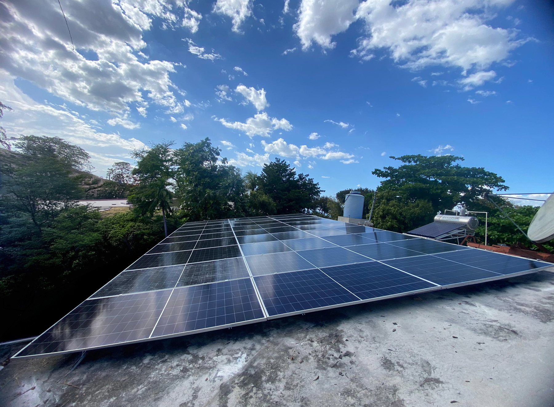 Rooftop solar array on a home under a bright Haitian sky